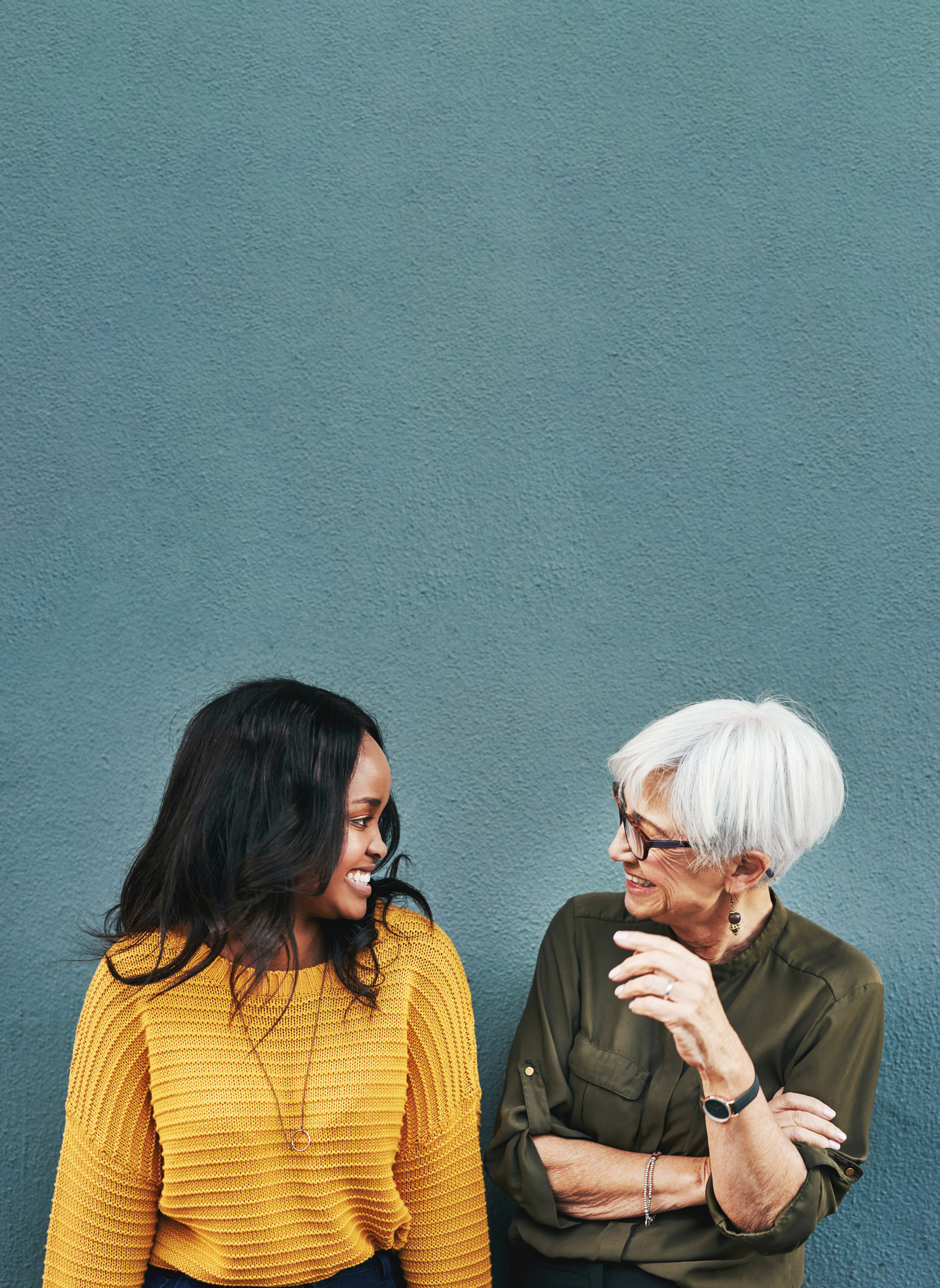 2 women talking, one is older the other is younger, communicating with use of hand gestures, hidden hearing loss.