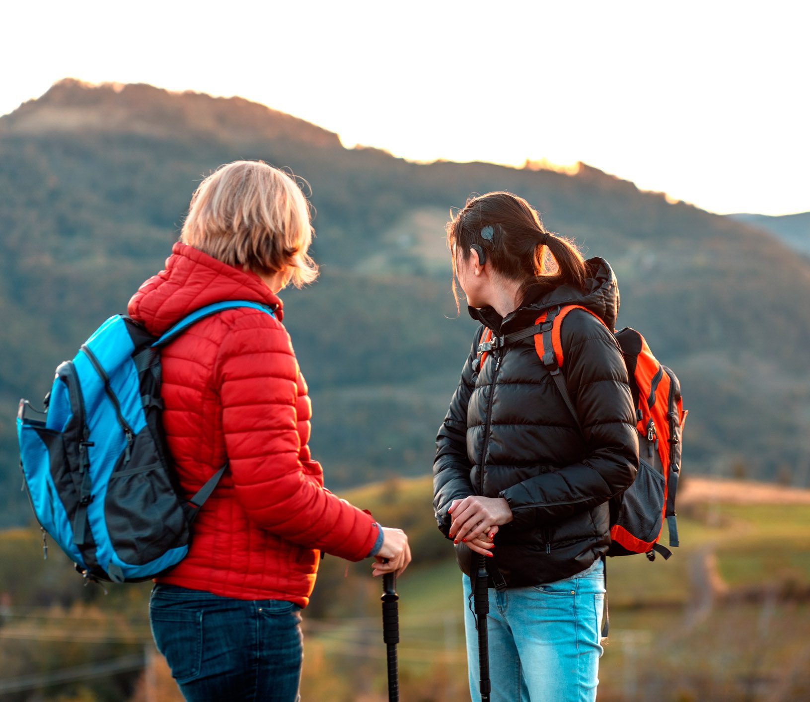 Two woman on a nature walk wearing a cochlear implant